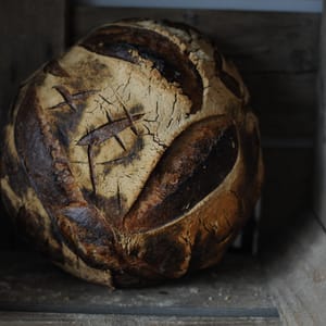 large sourdough loaf in apple crate